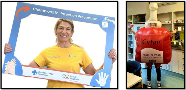 A woman is pictured holding a sign that says 'champions for infection prevention' next to a person in an inflatable hand sanitiser costume